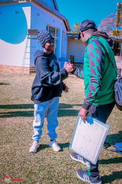 An academy coach working with a young player