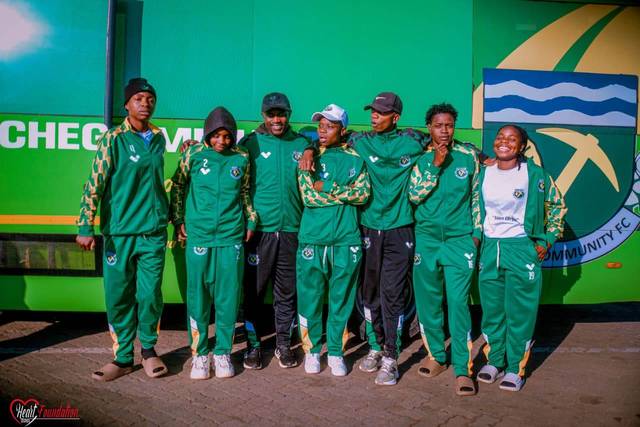 Squad members beside the club team bus